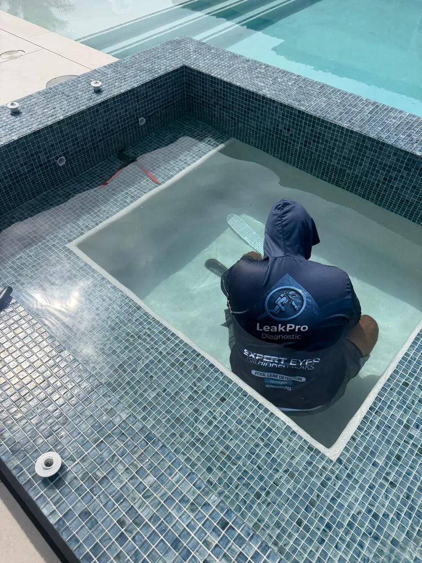 LeakPro Diagnostic technician in uniform inspecting a spa for leaks