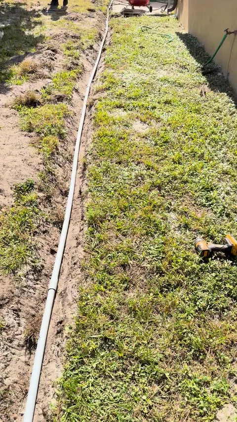 Trench dug across the yard for the new line.