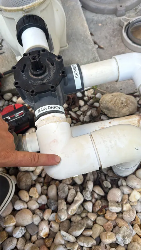 Working from the equipment, on the main drain line.