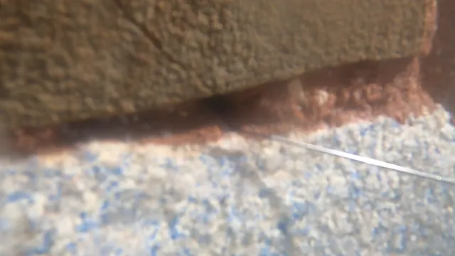 The gap at the base of the rocks, underwater.