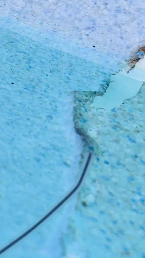 Crack running down the pool wall.